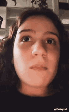 a close up of a woman 's face with the words gifsdayrol below