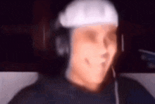 a blurry picture of a man wearing headphones and a helmet