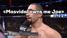 a man talking into a microphone with the words masvidal owns me joe