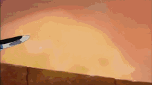 a cartoon character with a blue hand is standing on a cliff .