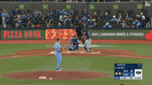a baseball game is being played in front of a pizza nova advertisement