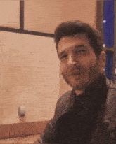 a man with a beard wearing a brown leather jacket
