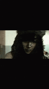 a woman wearing a furry hat and glasses is dancing