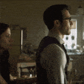 a man and a woman are looking at each other in a kitchen with a watermark that says victoriaspadaily
