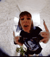 a woman wearing a black t-shirt with a picture of a girl on it