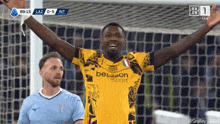 a soccer player wearing a betsson sport jersey celebrates with his arms in the air
