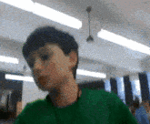 a blurry picture of a boy in a green sweater