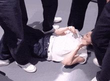a person laying on the floor with their hands on their face