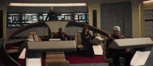 a group of people are sitting in a room with a sign that says ' ee ' on it