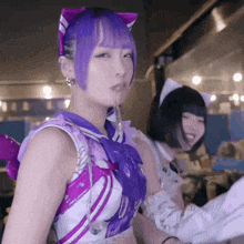 a woman with purple hair and a cat ear costume