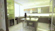 a woman is standing in a kitchen with the words byoo.tu on the wall