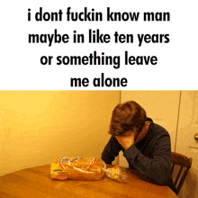 a man sits at a table with a loaf of bread in front of him and the words i dont fuckin know man maybe