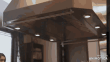 a stainless steel hood with lights on it is made in animotica