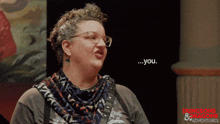 a woman wearing glasses and a scarf is talking about dungeons and dragons