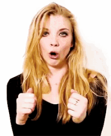 a woman with long blonde hair is making a funny face