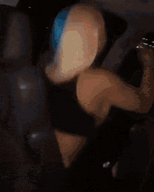 a person with blue hair is wearing a black shirt with yellow letters that says cd def