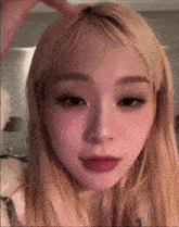a close up of a woman 's face with blonde hair .
