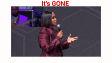 a large crowd of people in a large auditorium with the words it 's gone above them