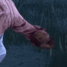 a person in a pink shirt with a skull on their arm