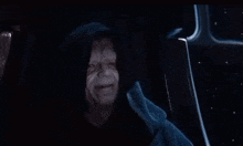 a man in a hooded cloak is giving a thumbs up