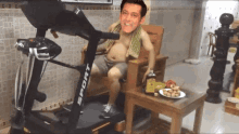 a man is sitting on a treadmill that says sport