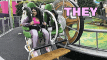 a woman sits on a roller coaster with the word they written above her