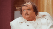 a man with a mustache is wearing a white shirt and a white coat
