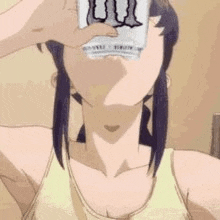 a woman is drinking a can of energy drink from a glass .