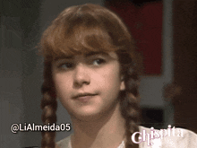 a close up of a girl with braids and the name chispita