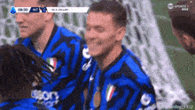 a group of soccer players are smiling during a game on tv