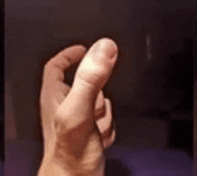 a close up of a person 's hand with their thumb up .