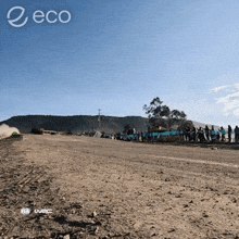 a group of people are standing on the side of a dirt road with the word eco on the bottom