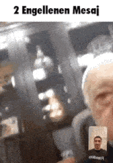 a man is talking to another man on a video call while wearing a black t-shirt .