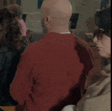 a woman wearing sunglasses stands next to a man