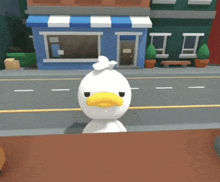 a white duck with a yellow beak is standing on a table in front of a building