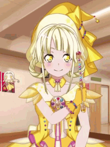 a girl in a yellow dress is holding a bracelet