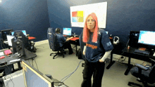 a woman with pink hair is wearing a blue shirt that says orange