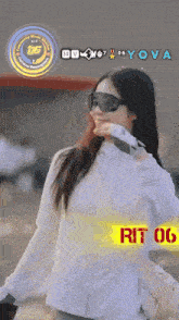 a woman wearing sunglasses and a white jacket with the word yova on the bottom right