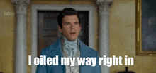 a man in a blue suit says " i oiled my way right in " in front of a door
