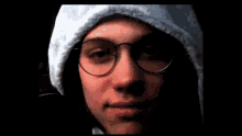 a close up of a person wearing glasses and a hat
