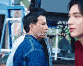 a man and a woman are standing next to each other and talking to each other .