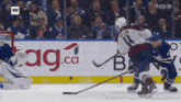 a hockey game is being played in front of a sign that says " ag.ca "