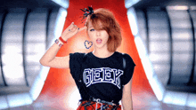 a woman wearing a black shirt that says geek on the front