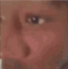 a close up of a man holding a straw in his mouth .