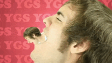 a man with a reflection of another man in his mouth with ygs ygs written in the background