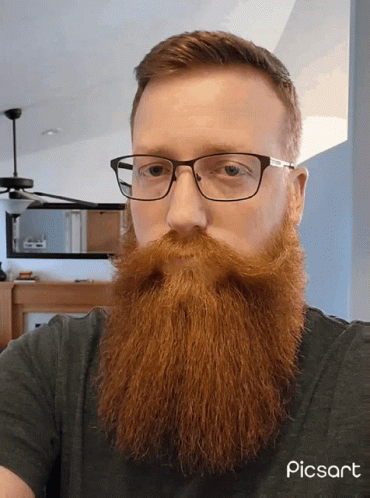 a man with a beard wearing glasses and a picart logo
