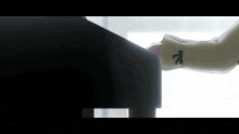 a close up of a person playing a piano with the letter k on their sleeve