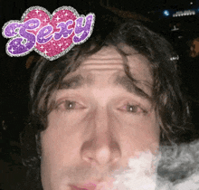 a man smoking a cigarette with the word sexy on his head