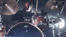 a man is playing drums with a shirt that says noble records