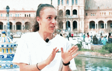 a woman wearing a white t-shirt that says ' nike ' on the front